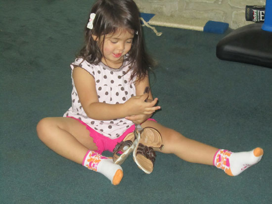 Yaya puts her shoes on "all by myself"