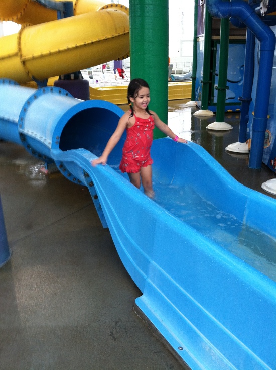 Happily coming out of her favorite blue slide