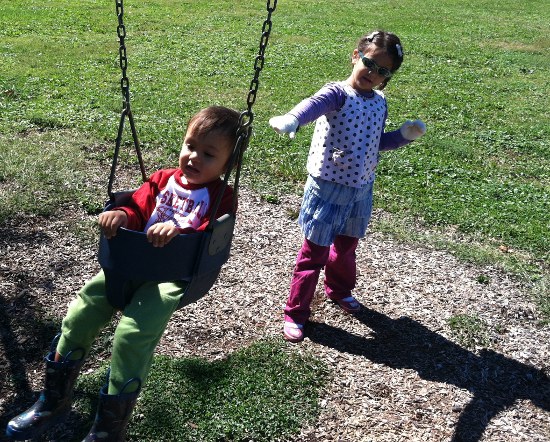Pushing Adik on the baby swings