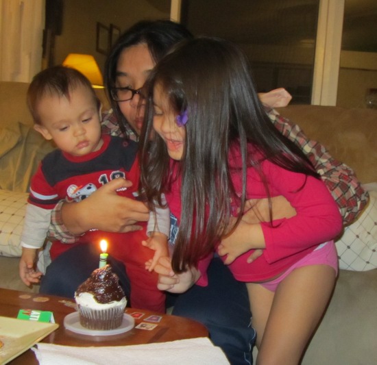Yaya helps to blow out the candle