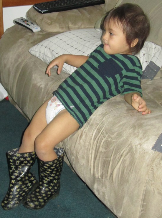 Yaya's boots and a diaper - a good look for a two-year-old