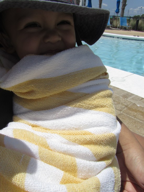 Burrito Adik wrapped up and protected from the sun and wind in Mama's arms