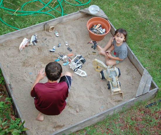 Mason cleared his sandbox and found cars for Adik to play with