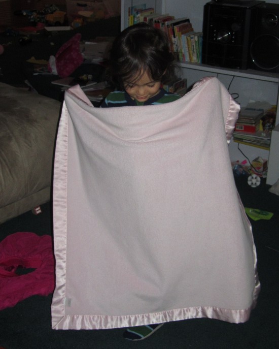 Playing with Yaya's pink baby blanket
