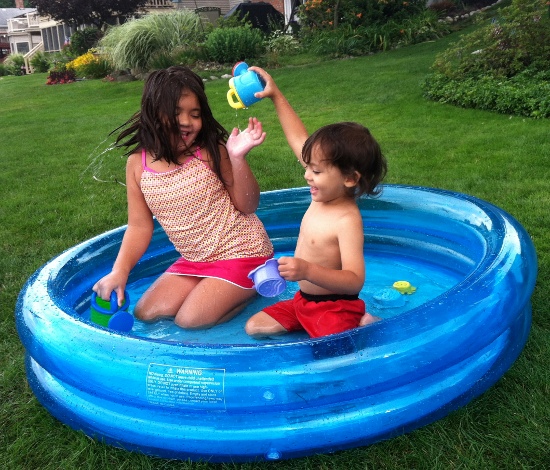 Playing in Olivia from next door's paddling pool