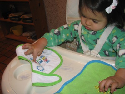 Learning to read her bibs
