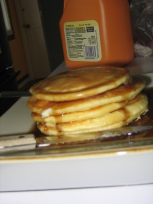 Stack of pancakes drizzled with maple syrup