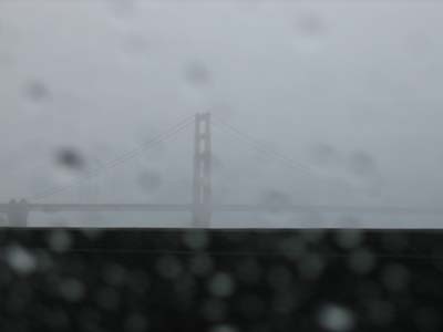 Golden Gate Bridge far off, foggy, and rainy