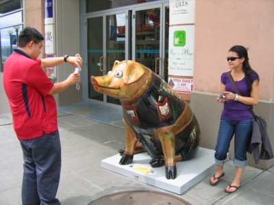 Taking pictures of pig sculptures