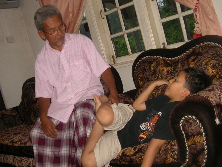 Tok Bah converses with his grandson