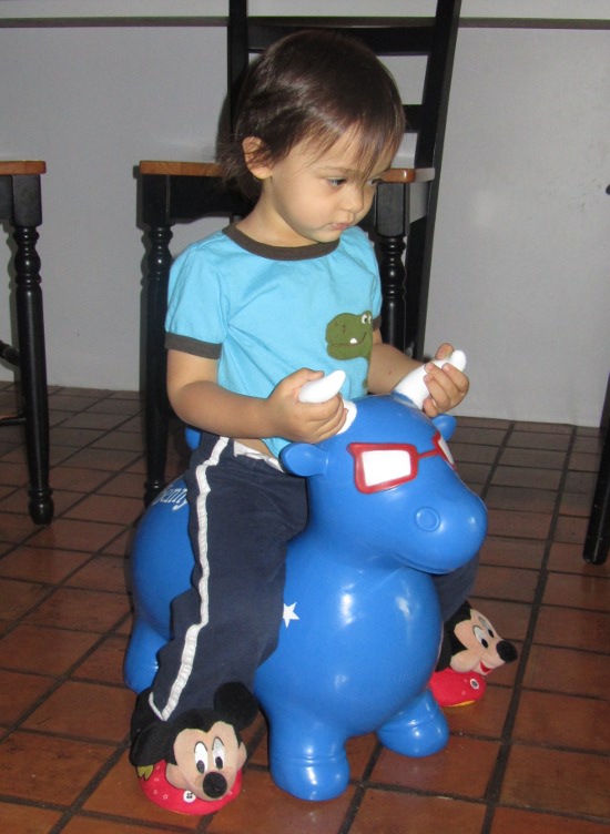 Adik rides Benny the Bull in his new Mickey Mouse slippers