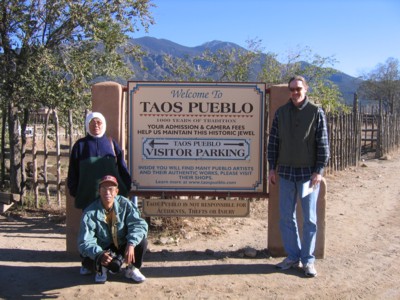 Mak, Abah and Vin by the Taos Pueblo sign